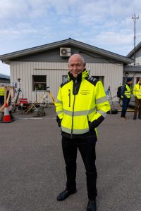 mann synlighetsjakke foran bygg
